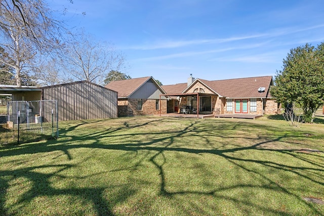 rear view of property with a patio area and a lawn