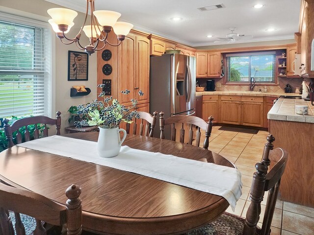 2104 Pinecrest Dr, Jasper, TX 75951 - dining area with ceiling fan, light tile patterned floors, ornamental molding, a chandelier, and recessed lighting