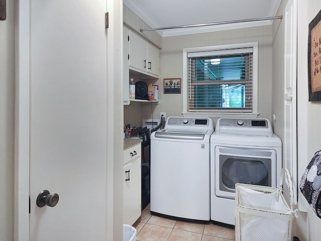 2104 Pinecrest Dr, Jasper, TX 75951 - laundry room with cabinet space, washing machine and clothes dryer, ornamental molding, and light tile patterned floors