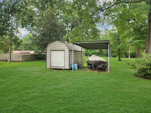 2104 Pinecrest Dr, Jasper, TX 75951 - view of yard featuring a storage shed, a carport, and view of wooded area