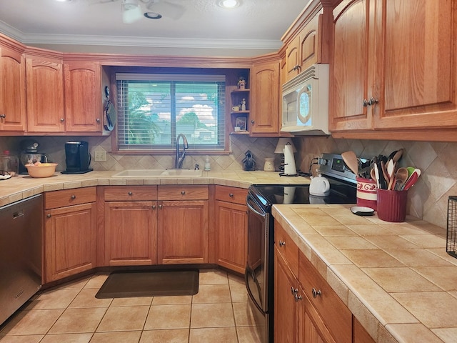 2104 Pinecrest Dr, Jasper, TX 75951 - kitchen featuring white microwave, range with electric cooktop, tile countertops, stainless steel dishwasher, and ornamental molding