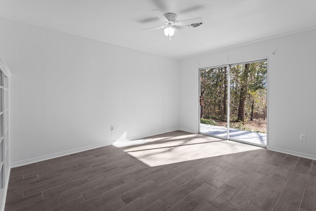 empty room with ceiling fan, dark wood-type flooring, and ornamental molding