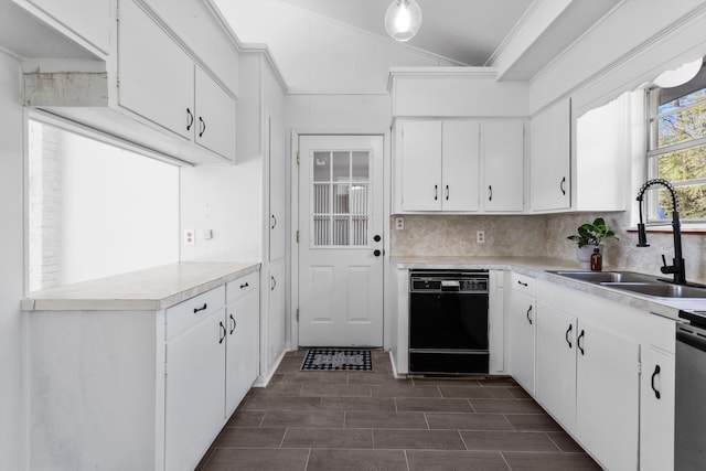 kitchen with sink, white cabinets, lofted ceiling, and black dishwasher