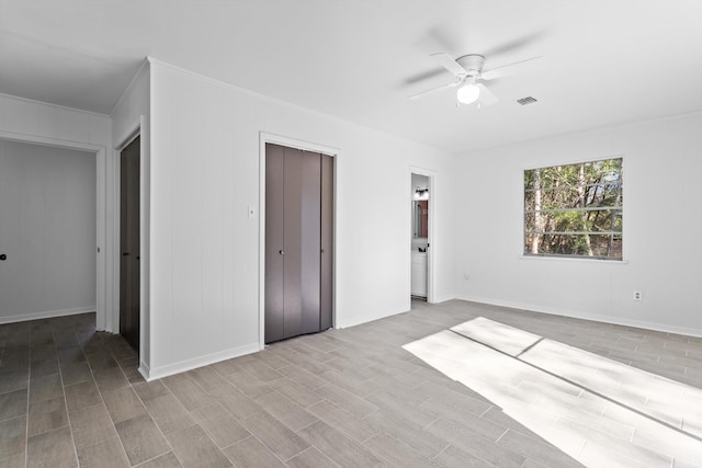 unfurnished bedroom with ceiling fan, crown molding, and light hardwood / wood-style floors