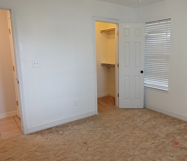 157 Sandalwood, Lufkin, TX 75904 - unfurnished bedroom featuring a spacious closet, carpet flooring, and baseboards