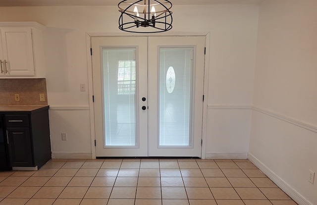 157 Sandalwood, Lufkin, TX 75904 - doorway to outside featuring french doors, a chandelier, light tile patterned floors, and baseboards