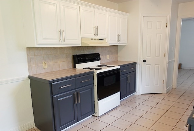 157 Sandalwood, Lufkin, TX 75904 - kitchen with range with electric cooktop, extractor fan, white cabinetry, blue cabinetry, and tasteful backsplash