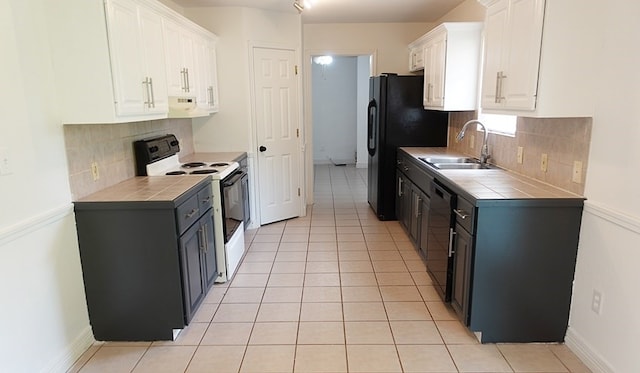 157 Sandalwood, Lufkin, TX 75904 - kitchen with black appliances, a sink, tile countertops, and white cabinets