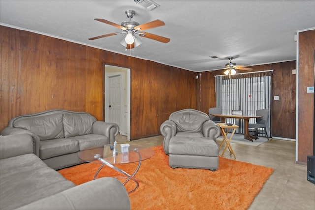 408 Bob St, Lufkin, TX 75904 - living area featuring ceiling fan, wood walls, visible vents, and finished concrete flooring