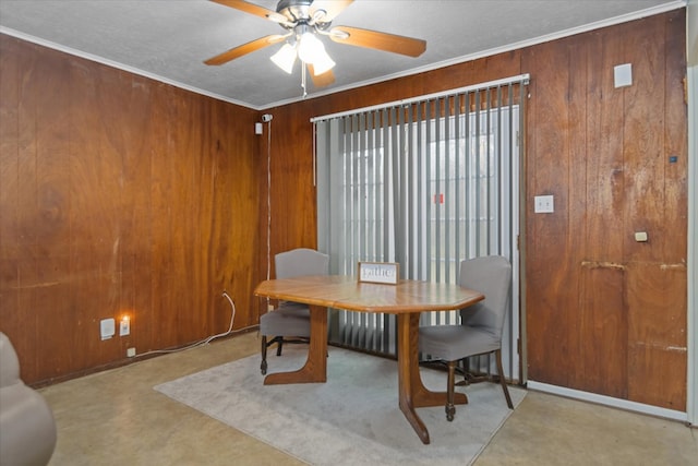 408 Bob St, Lufkin, TX 75904 - dining room with ceiling fan, wooden walls, and finished concrete flooring