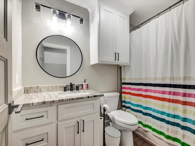 bathroom with vanity, hardwood / wood-style flooring, curtained shower, and toilet