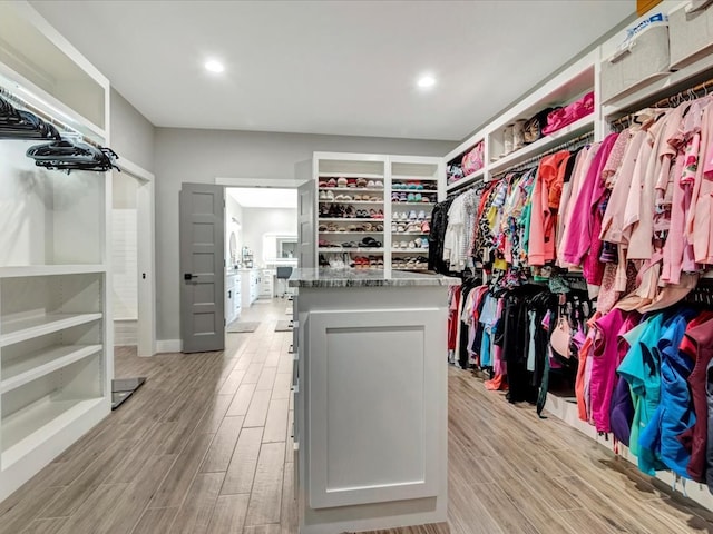 walk in closet with light wood-type flooring