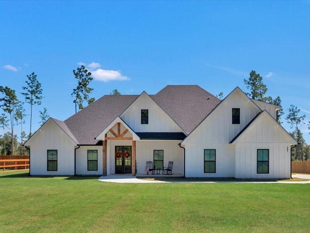 modern farmhouse featuring a patio area, a front yard, and french doors