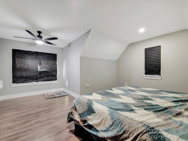 bedroom with vaulted ceiling, light wood-type flooring, and ceiling fan