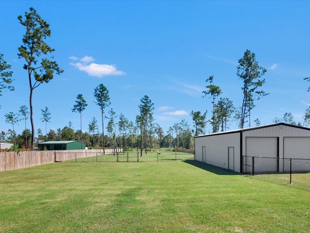 view of yard with a garage and an outdoor structure