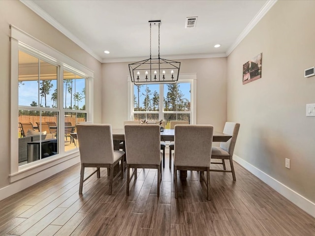 dining room with ornamental molding and an inviting chandelier