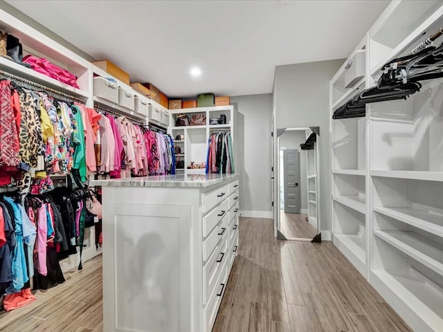 walk in closet with light wood-type flooring