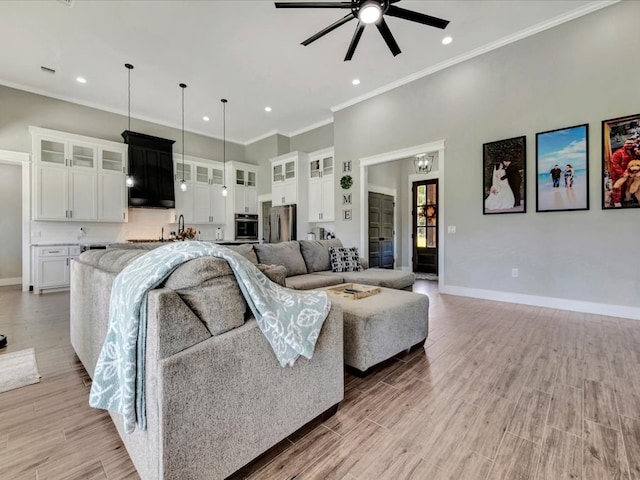 living room featuring crown molding and ceiling fan