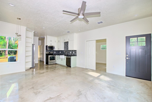 unfurnished living room with a textured ceiling, ceiling fan, crown molding, and sink