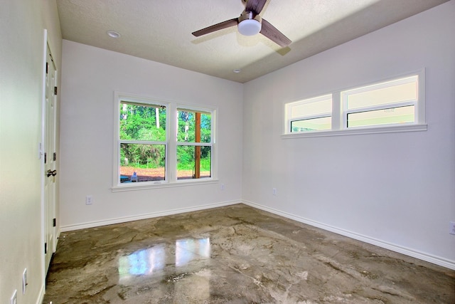 empty room with concrete flooring, a textured ceiling, and ceiling fan