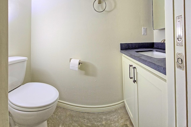 bathroom featuring tile patterned floors, vanity, and toilet