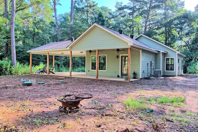 view of front of home featuring a fire pit, ceiling fan, a patio area, and central air condition unit