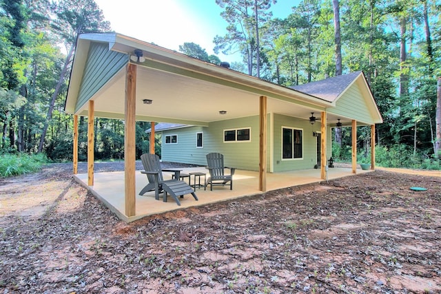 141 Ensign Dr, Hemphill, TX 75948 - back of house featuring a patio, a ceiling fan, and roof with shingles