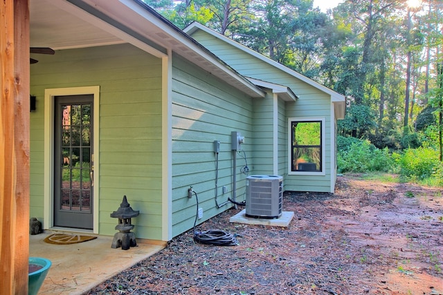 view of side of home featuring central AC