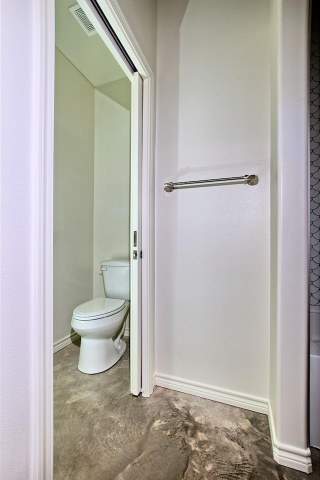 141 Ensign Dr, Hemphill, TX 75948 - bathroom with concrete flooring, toilet, and baseboards