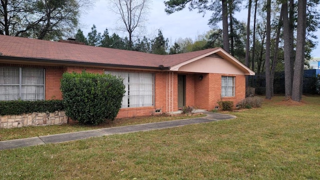 ranch-style home with a front lawn