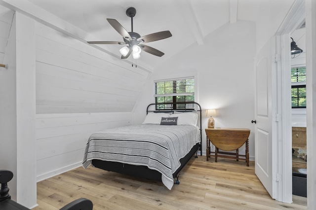 bedroom with ceiling fan, lofted ceiling with beams, and light hardwood / wood-style flooring