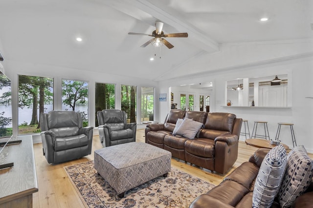 living room with ceiling fan, beam ceiling, light wood-type flooring, and high vaulted ceiling