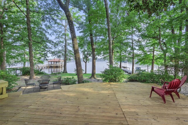 deck featuring a water view and an outdoor fire pit