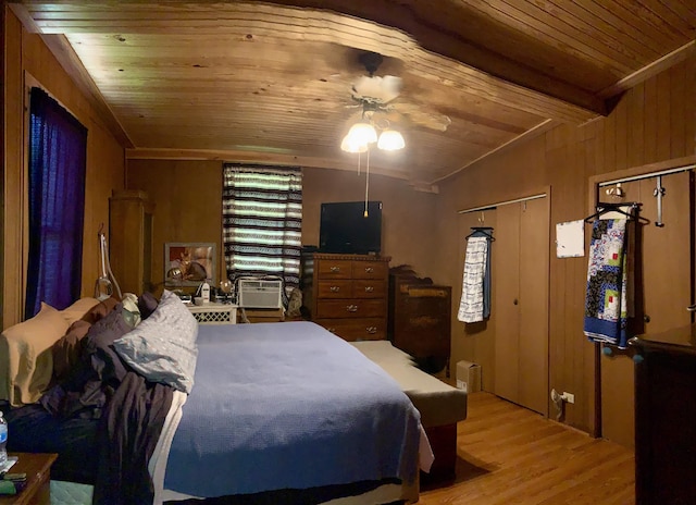 bedroom featuring ceiling fan, wooden ceiling, wood walls, lofted ceiling, and light wood-type flooring