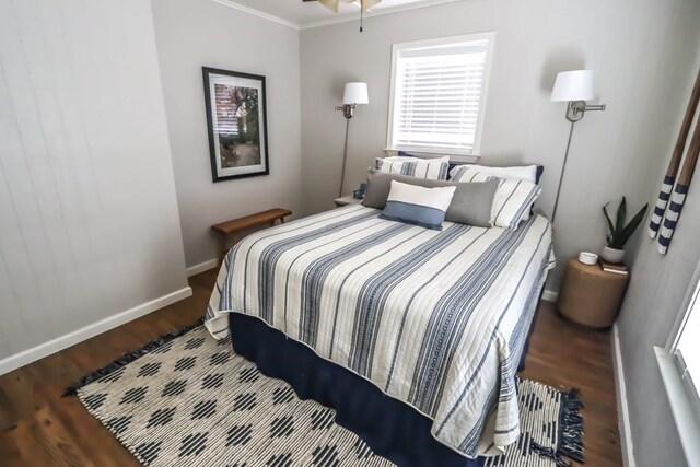 bedroom featuring baseboards and wood finished floors