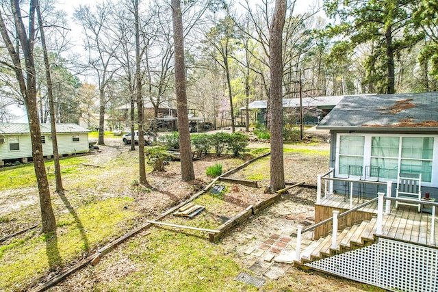 view of yard with a garden and a deck