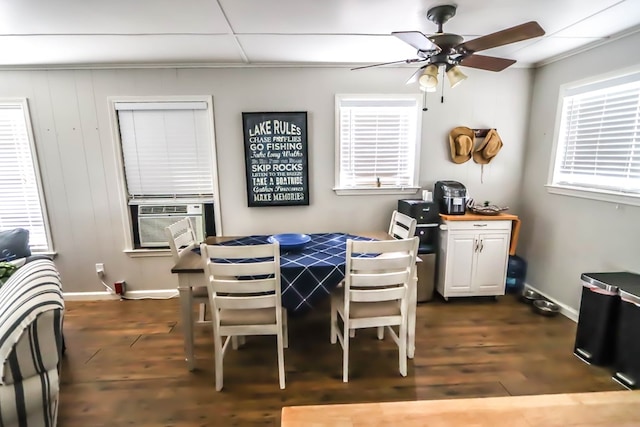 dining area featuring cooling unit, baseboards, dark wood-type flooring, and ceiling fan