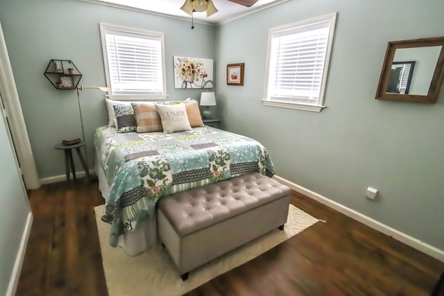 bedroom featuring baseboards and wood finished floors