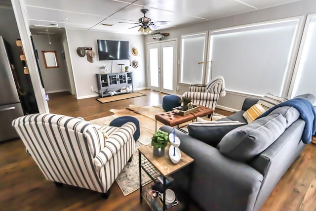 living room with wood finished floors, french doors, baseboards, attic access, and ceiling fan