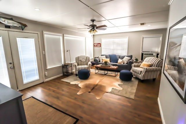living area with cooling unit, a ceiling fan, wood finished floors, baseboards, and french doors