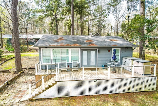 back of property with french doors and a wooden deck