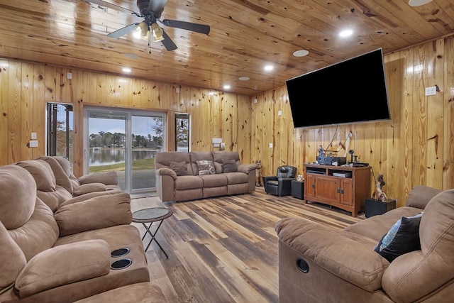 living room featuring ceiling fan, wood walls, hardwood / wood-style floors, and wooden ceiling