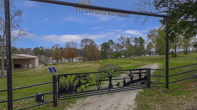 view of gate with a yard