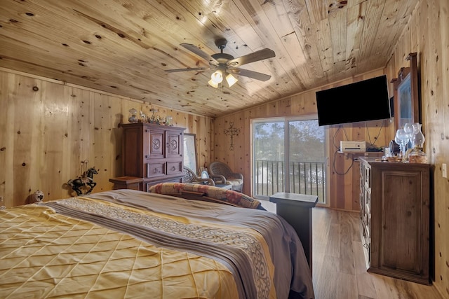 bedroom featuring wood walls, vaulted ceiling, light hardwood / wood-style flooring, wooden ceiling, and access to outside