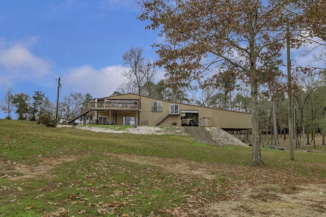 back of house with a wooden deck and a lawn