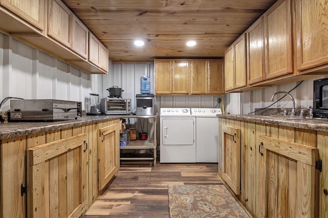 laundry area featuring washing machine and dryer, sink, wooden ceiling, and dark hardwood / wood-style floors