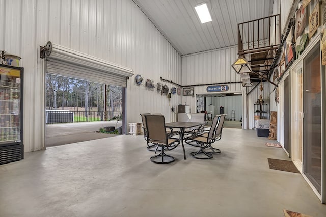 dining room featuring wine cooler and concrete floors