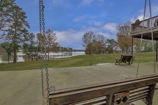 view of yard with a water view and a patio area