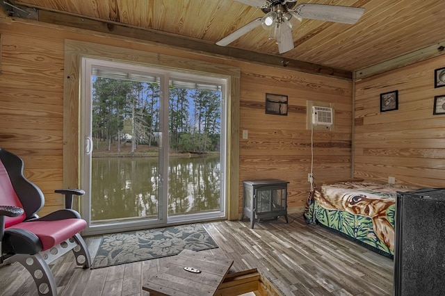 bedroom with wood walls, hardwood / wood-style flooring, ceiling fan, wooden ceiling, and a wall unit AC