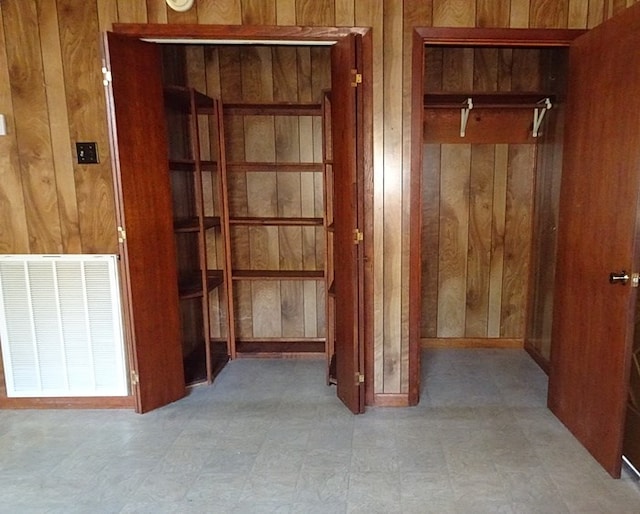 corridor featuring wood walls